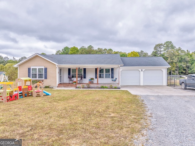 ranch-style home featuring covered porch, a playground, a front yard, and a garage