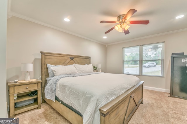 bedroom featuring ceiling fan, light colored carpet, and crown molding