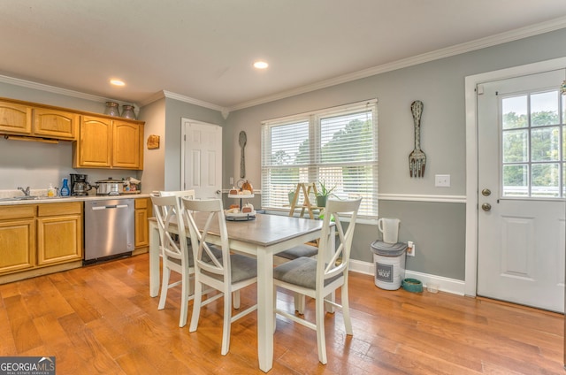 dining area with crown molding, light hardwood / wood-style floors, sink, and plenty of natural light