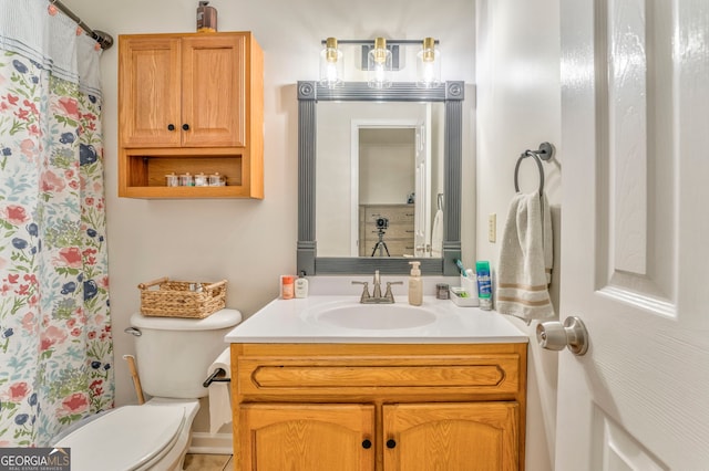 bathroom featuring walk in shower, vanity, and toilet