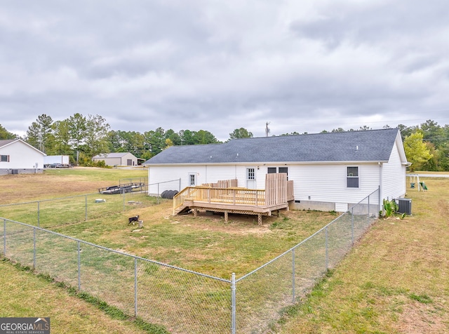 back of house featuring a lawn, a deck, and central AC unit