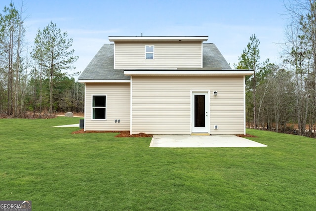 rear view of house with a yard and a patio