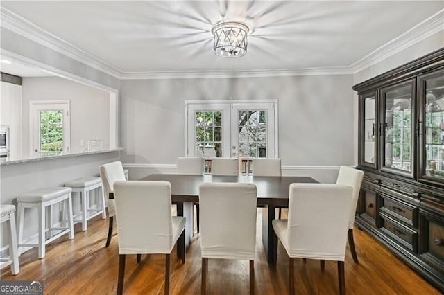 dining space with a notable chandelier, plenty of natural light, and dark wood-type flooring