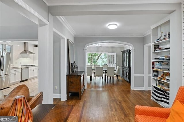 hallway featuring ornamental molding and dark hardwood / wood-style floors