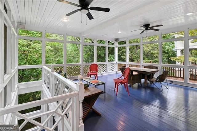 sunroom / solarium with wooden ceiling, a healthy amount of sunlight, and ceiling fan