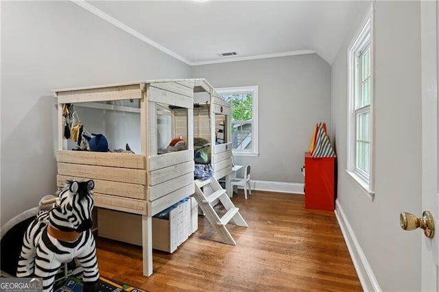 bedroom featuring lofted ceiling, hardwood / wood-style floors, and crown molding