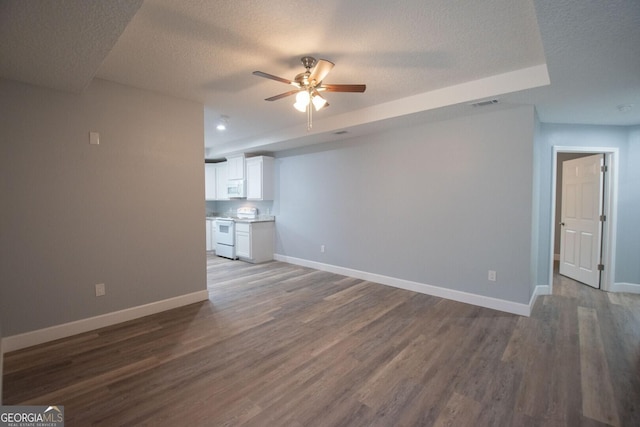 unfurnished living room with hardwood / wood-style flooring, ceiling fan, and a textured ceiling
