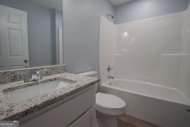full bathroom with vanity, toilet, shower / bath combination, and hardwood / wood-style floors