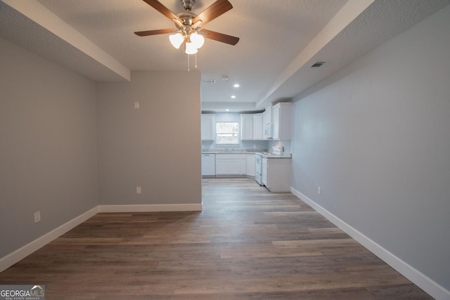 unfurnished living room featuring ceiling fan, wood-type flooring, and a textured ceiling