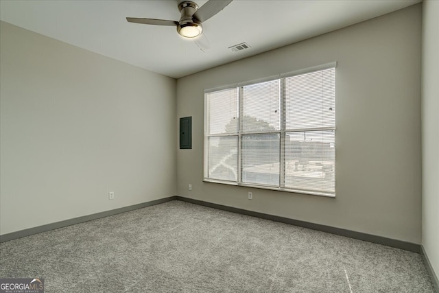 carpeted spare room with electric panel and ceiling fan