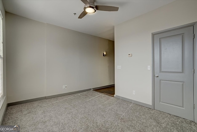 carpeted empty room with ceiling fan