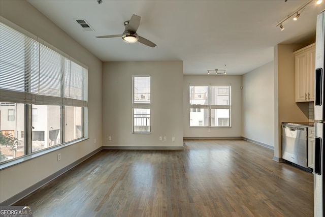 unfurnished living room with ceiling fan, wood-type flooring, and a healthy amount of sunlight