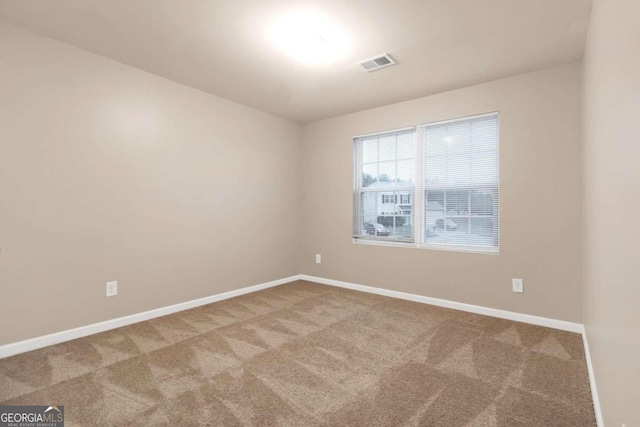 unfurnished room featuring carpet