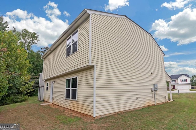 view of home's exterior with a garage and a yard