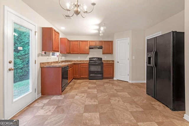 kitchen featuring black appliances, sink, pendant lighting, and a notable chandelier