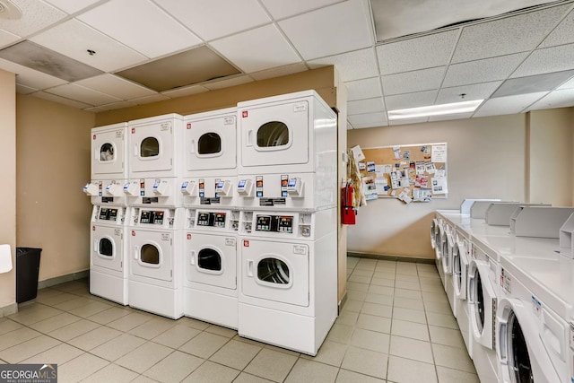 laundry area with independent washer and dryer, stacked washing maching and dryer, and light tile patterned floors