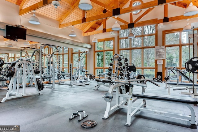 gym with high vaulted ceiling and wooden ceiling