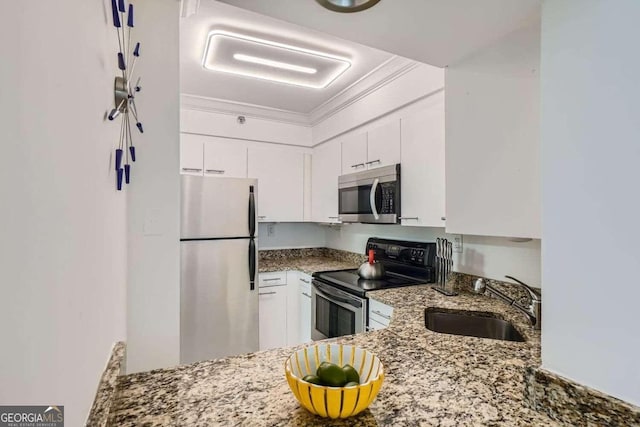 kitchen with sink, crown molding, appliances with stainless steel finishes, light stone countertops, and white cabinets