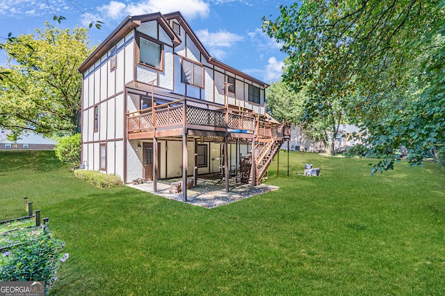 rear view of house with a wooden deck and a lawn