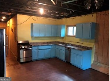 kitchen with stainless steel gas range, dishwasher, refrigerator, and dark hardwood / wood-style flooring