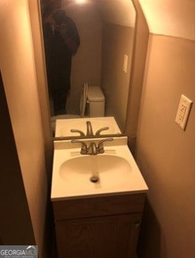 bathroom featuring vanity and toilet