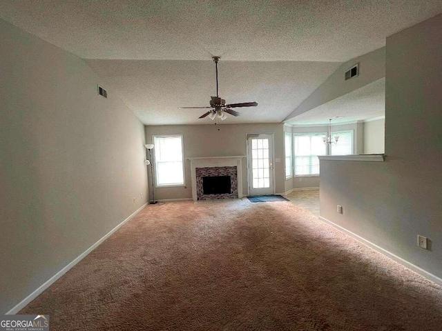 unfurnished living room with ceiling fan, light colored carpet, a textured ceiling, and vaulted ceiling