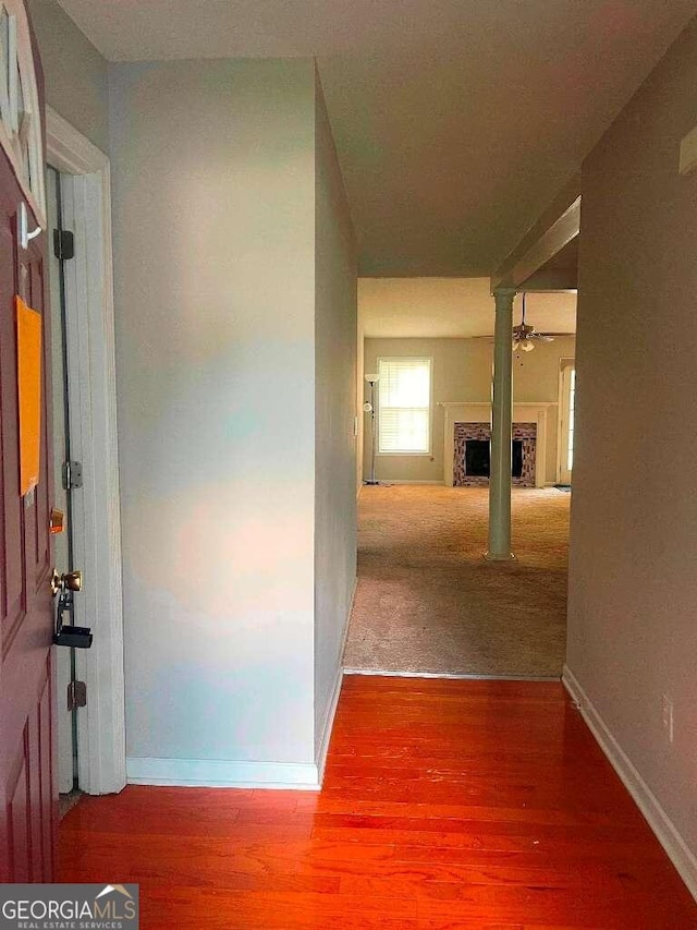 corridor with hardwood / wood-style floors