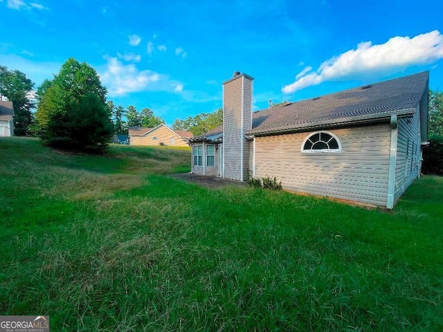 rear view of property featuring a yard