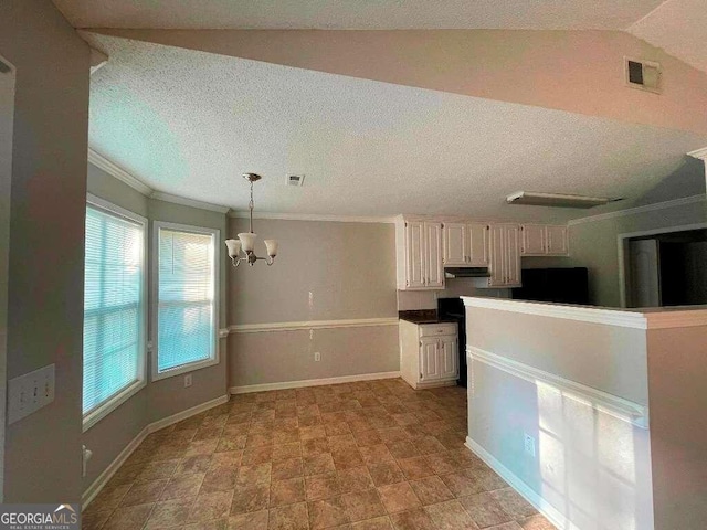 kitchen with a healthy amount of sunlight, white cabinets, a chandelier, and decorative light fixtures