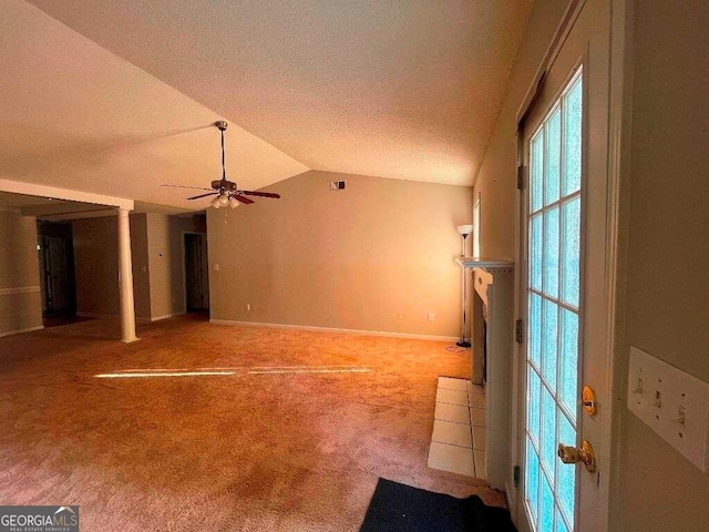 spare room with vaulted ceiling, ceiling fan, carpet floors, and a textured ceiling