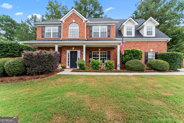 view of front of property featuring a porch and a front lawn