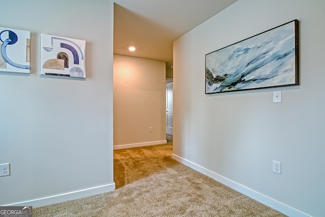 corridor featuring light carpet