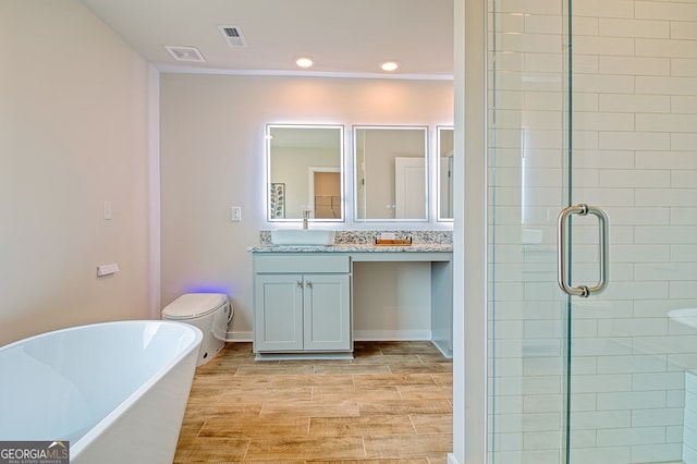 full bathroom featuring vanity, toilet, plus walk in shower, and hardwood / wood-style flooring