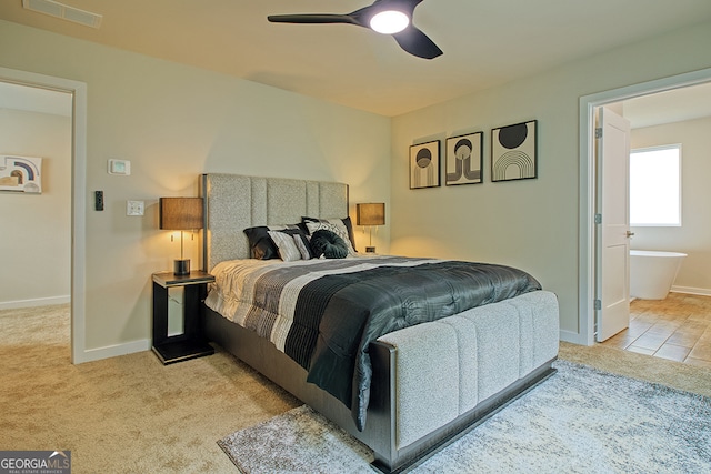 bedroom featuring ensuite bath, ceiling fan, and light colored carpet