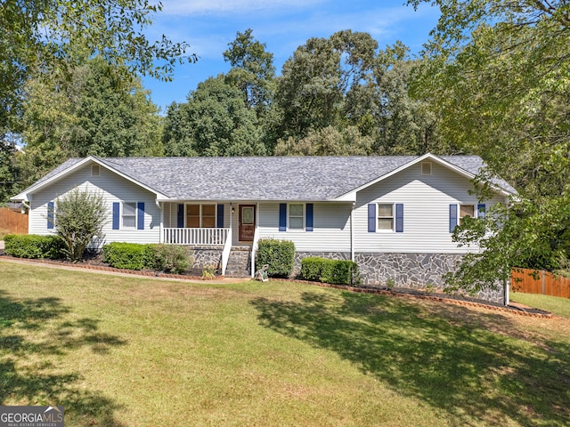 ranch-style house with a front lawn and covered porch