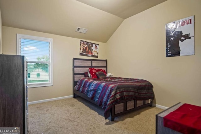 carpeted bedroom with vaulted ceiling