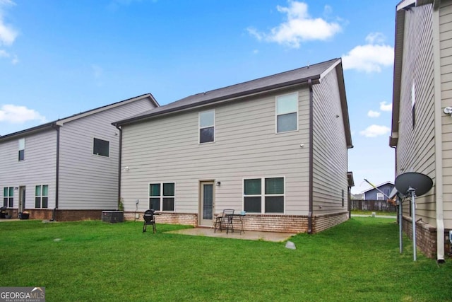 rear view of property with a lawn and a patio