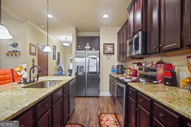 kitchen featuring pendant lighting, sink, appliances with stainless steel finishes, light stone countertops, and dark hardwood / wood-style flooring