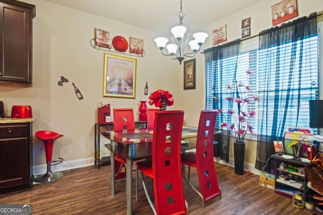 dining space featuring an inviting chandelier and dark hardwood / wood-style flooring