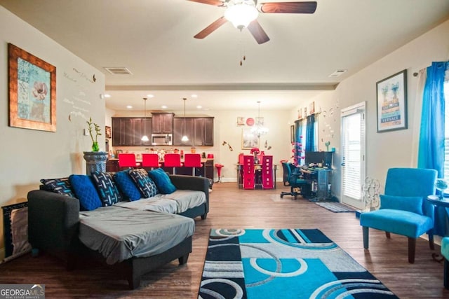 living room with ceiling fan and hardwood / wood-style floors