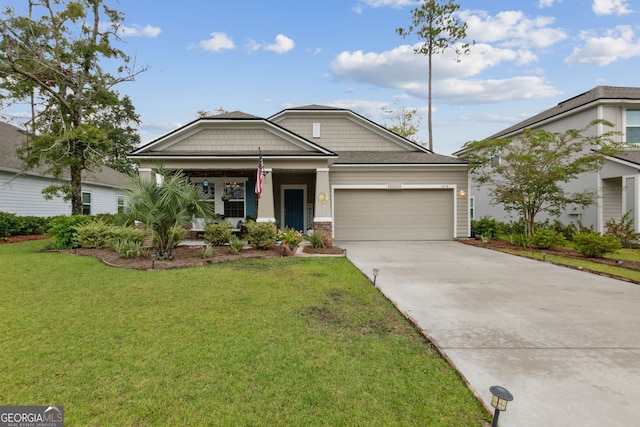 view of front of home featuring a front yard, a garage, and covered porch