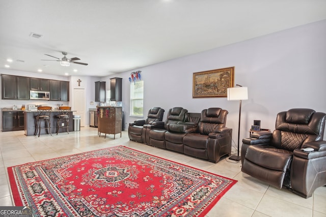 living room with ceiling fan and light tile patterned floors