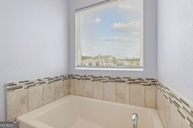 bathroom with a tub to relax in