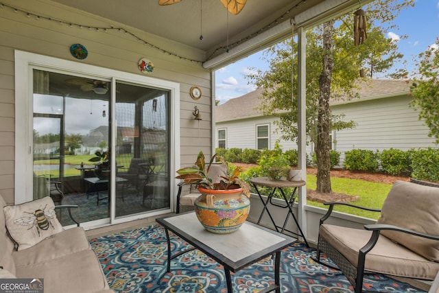 sunroom / solarium featuring ceiling fan and a wealth of natural light