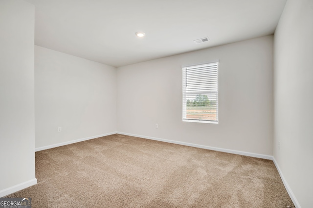 spare room featuring carpet, visible vents, baseboards, and recessed lighting