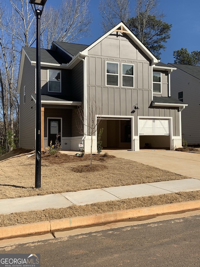 view of front of house with an attached garage, driveway, and board and batten siding