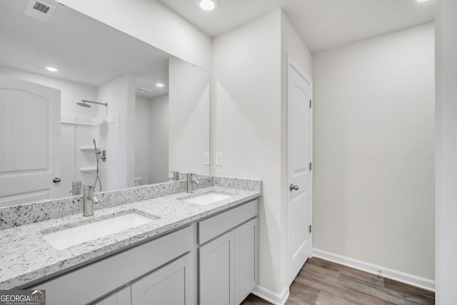 full bathroom with toilet, visible vents, a shower, and a sink