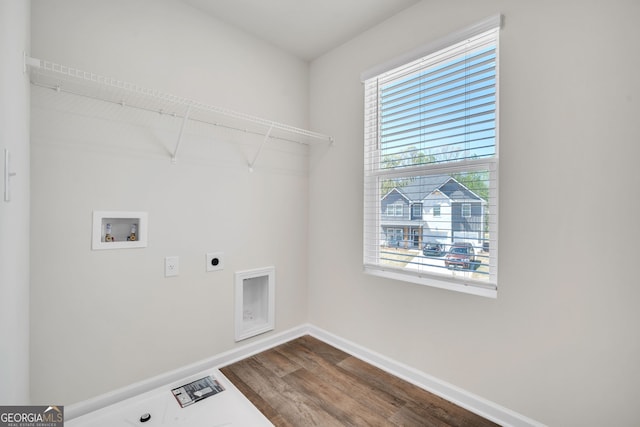 washroom featuring hookup for a washing machine, hookup for an electric dryer, laundry area, dark wood-style flooring, and baseboards