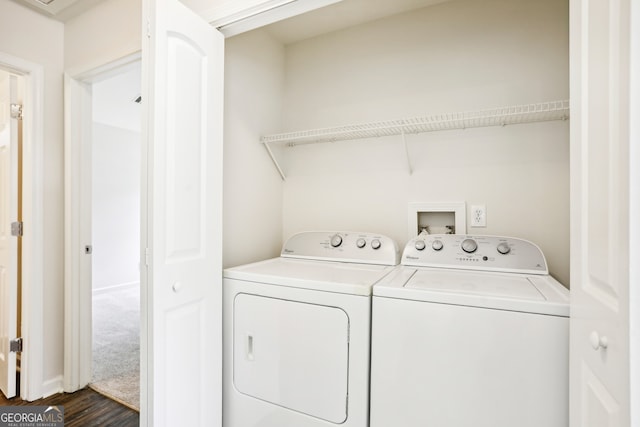 laundry area with washing machine and dryer and dark wood-type flooring