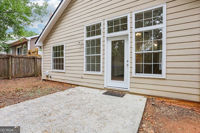 view of exterior entry featuring a patio area